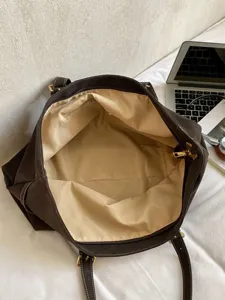 Grote donkerbruine shopper, casual damestas met matte textuur voor dagelijks gebruik.