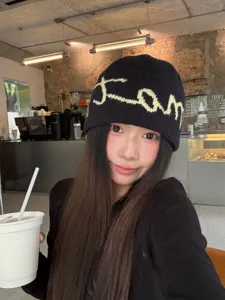 Detailed view of the Korean minimalist letter knitted beanie hat in cozy black wool material.