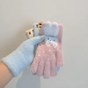 Close-up detail of cute cat jacquard thermal winter gloves with plush cuffs and soft fleece lining.