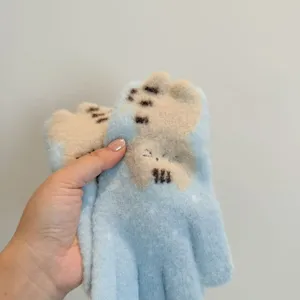 Close up detail of cute cat jacquard plush touch screen winter warm gloves for women.