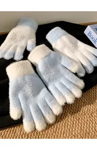 Plush knitted gloves detail showing blue white design with sparkling rhinestone snowflake pattern.