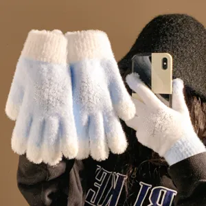 Plush knit winter gloves for women in light blue with sparkly rhinestone snowflake patterns.