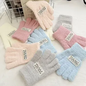 Cozy fuzzy knitted winter gloves featuring sweet candy colors and cute woven label details.