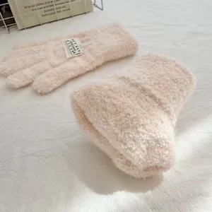 Children knitted gloves detail shot, warm autumn winter cute split finger design with white label.