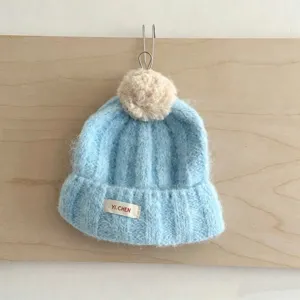 Bonnet en tricot pour enfants automne hiver, bonnet bleu clair avec pompon et jolie étiquette.