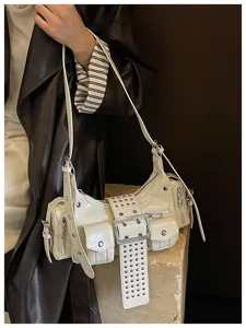 Detail van witte lakleer motor schoudertas, punkstijl met klinknagels en mooie zakken.