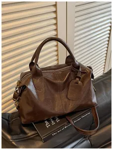 Vintage donkerbruine oliewas lederen Boston handtas met handvat en crossbody band detail.