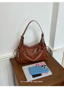 Detail shot of brown PU leather shoulder hobo bag, vintage casual commute daily style.