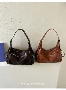 Detail view of minimalist Korean style slouchy shoulder hobo bag in brown leather finish.
