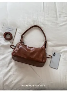 Chic brown leather shoulder underarm bag for women, stylish minimalist commuter casual handbag.