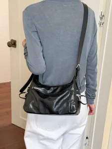 Black minimalist underarm shoulder bag for women, stylish casual commuting crossbody bag.