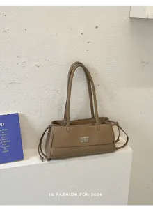 Vintage gewatteerde schoudertas voor dames, elegante PU lederen baguette tas met draaisluiting.