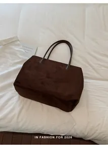 Gedetailleerd overzicht van de retro bruine suède tote bag met zachte textuur en ruime inhoud.