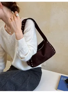 Detail der braunen Wildleder Umhängetasche mit Nieten, stylische Retro Achseltasche chic.