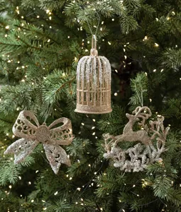 Champagne glitter Christmas tree hanging ornaments detail view with birdcage and bow decor