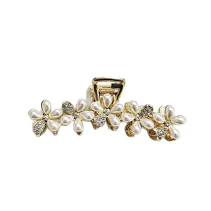 Elegant gold hair claw clip with pearl flowers and rhinestones for thick hair styling.