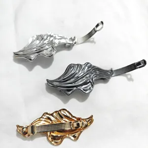 Metal hair barrette set with unique water wave geometric design in silver gold and gunmetal colors.