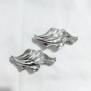 Metallic silver wavy hair clip set, unique geometric barrette for women styling detail.