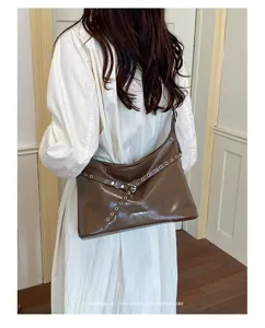 Retro PU leather motorcycle shoulder bag for women, chic hobo tote bag with metal grommets.