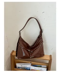 Vintage brown PU leather shoulder bag with metal eyelets, stylish hobo motorcycle bag for women.