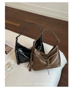 Vintage PU leather motorcycle shoulder tote bag with metal grommet details for women.