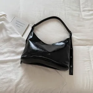 Classic black PU leather shoulder bag for women, chic hobo motorcycle style handbag.