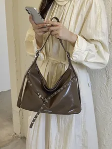 Retro brown patent leather hobo shoulder bag for women, chic motorcycle style handbag with metal eyelets.