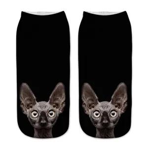 Close-up detail of the 3D printed Sphynx cat face pattern on black ankle socks fabric.
