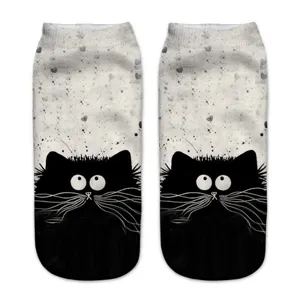 Detailed view of the 3D printed cat socks showing the cute black cat face and splatter background.