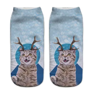 Close-up detail of 3D cat face and reindeer antlers print on soft blue sock fabric.