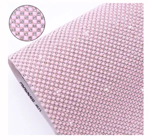 Close-up detail of pink resin rhinestone mesh sheet with hot melt adhesive for DIY crafts.