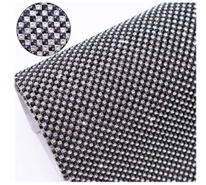 Close-up detail of black and white rhinestone mesh sheet, sparkly crystal DIY craft fabric.