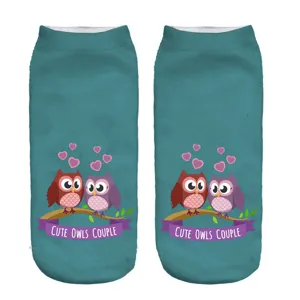 Close-up detail of the cute owl couple 3d print on the turquoise short ankle socks.