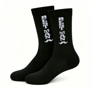 Close-up detail of black crew socks featuring white knitted Best Man text and mustache.