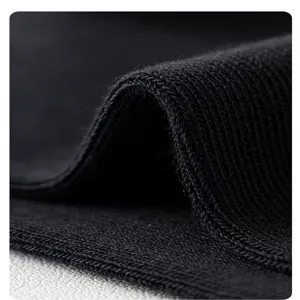 Close-up detail of black knitted fabric showing texture and soft material quality for socks.