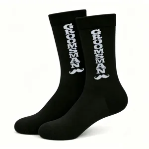 Black crew socks featuring a knitted groomsman text and mustache pattern, perfect for weddings.