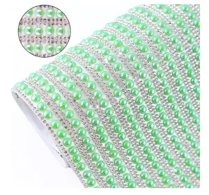Self-adhesive green pearl rhinestone ribbon roll close-up detail for DIY craft decoration.