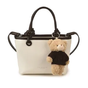 Chic contrast color women handbag with cute bear pendant, stylish shoulder cross body bag.