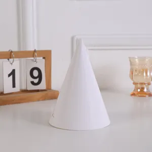 Plain white paper cone hat detail shot, blank DIY painting hat for kids crafts and art projects.