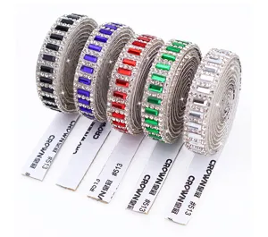 Close-up of colorful self-adhesive rhinestone strip rolls for DIY craft clothing decoration.