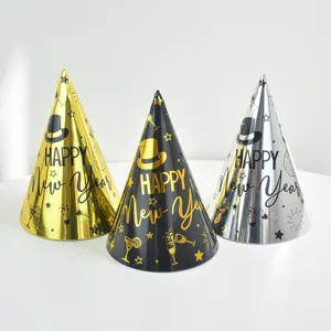 Detail shot of conical paper party hats in gold, black and silver with metallic New Year prints.