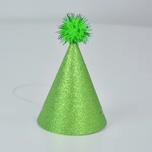 Green glitter cone birthday party hat detail view, sparkling pom pom decoration for celebration.