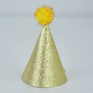 Gold glitter party hat detail, shiny conical birthday cap with yellow pom pom for celebration.