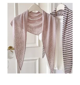 Nahaufnahme des rosa gestrickten Dreieckschals zeigt weiche Textur und stilvollen Fall.