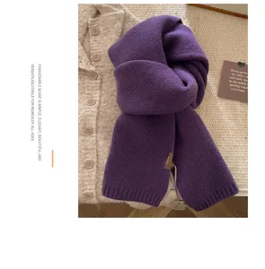 Detailed view of the soft purple knitted wool scarf texture, showing cozy winter style.