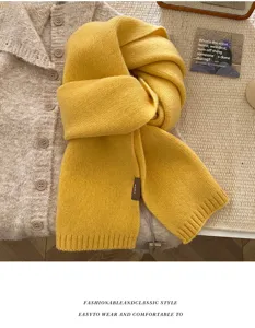 Detail view of a cozy yellow knitted scarf, soft texture, perfect winter accessory for women.