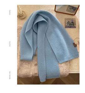 Cozy light blue pure wool knitted scarf for women, soft winter neck warmer accessory.