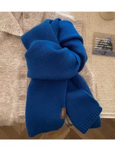 Cozy royal blue knitted scarf close-up, featuring ultra-soft texture and elegant winter style detail.