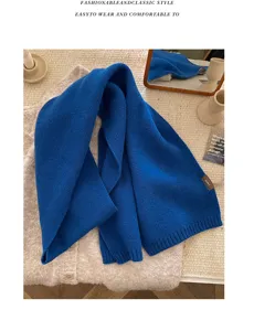 Detailed view of the soft blue knit scarf, premium wool material, cozy winter accessory style.