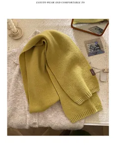 Detailed view of cozy knit wool scarf in mustard yellow, showing soft texture and premium quality.